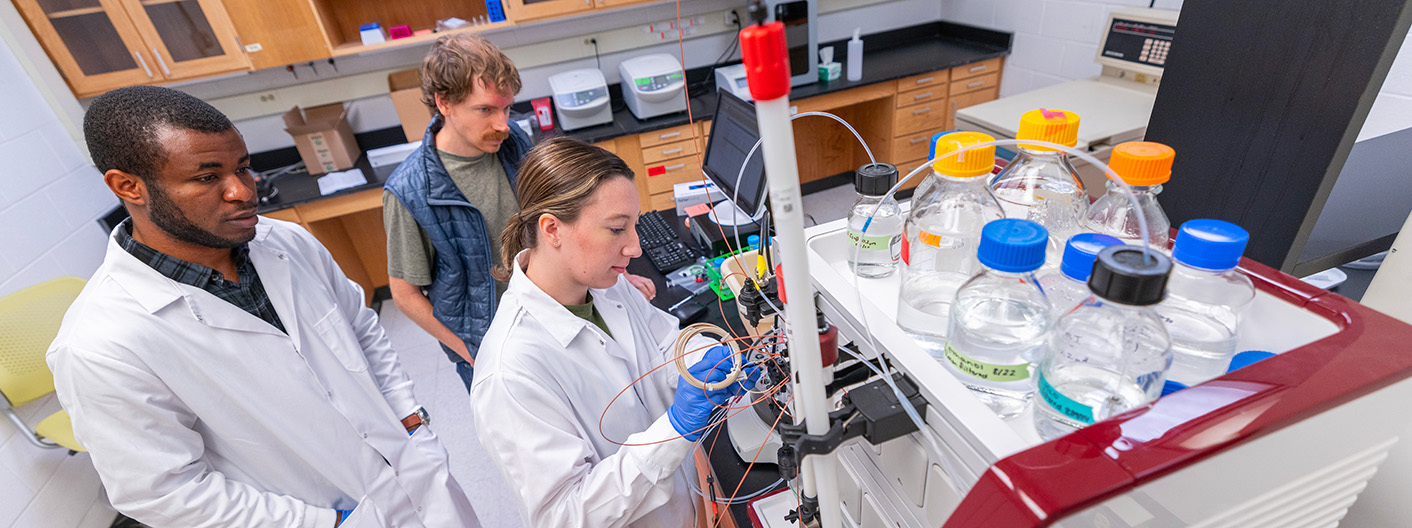 students in lab with professor