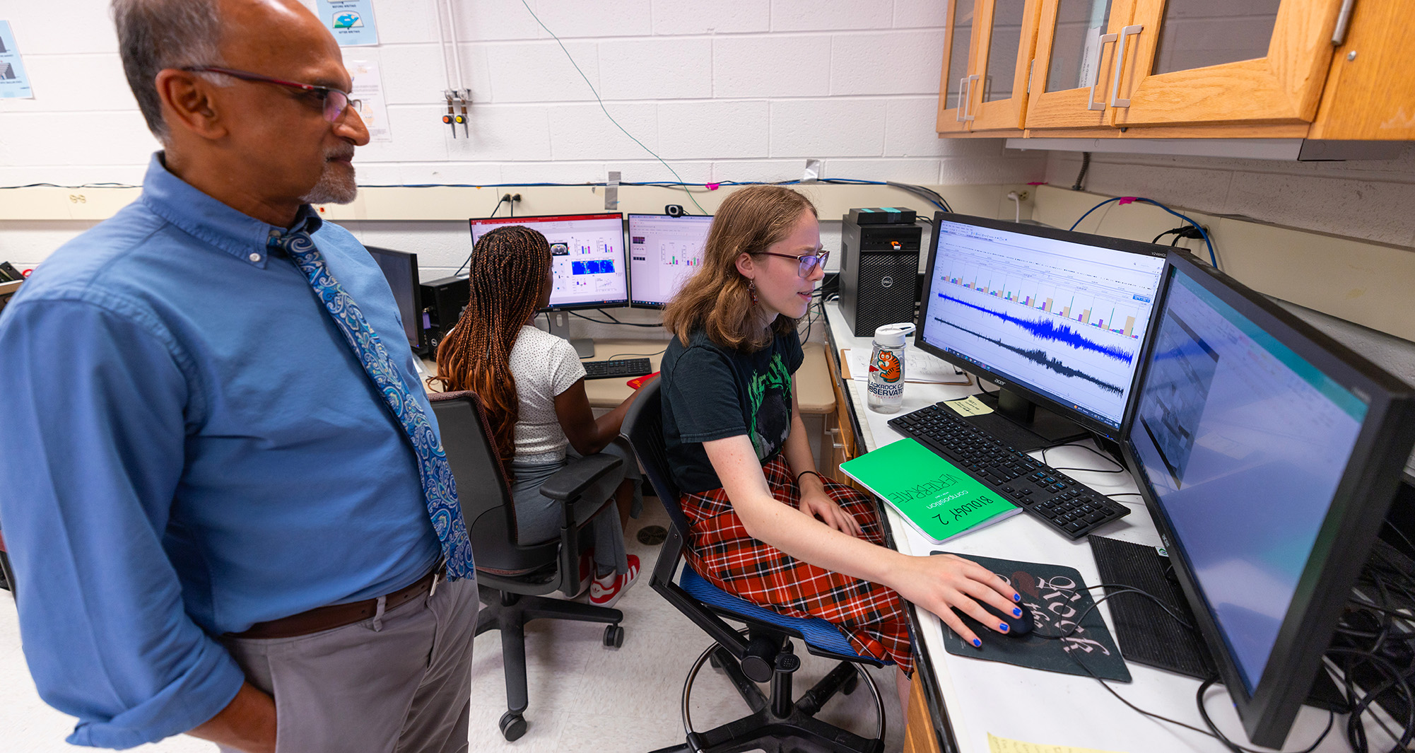 professor assisting student at computer