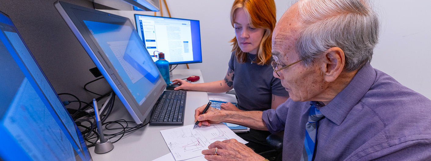 Faculty member working with student at computer