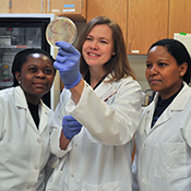 Dr. Krueder examining sample with researchers